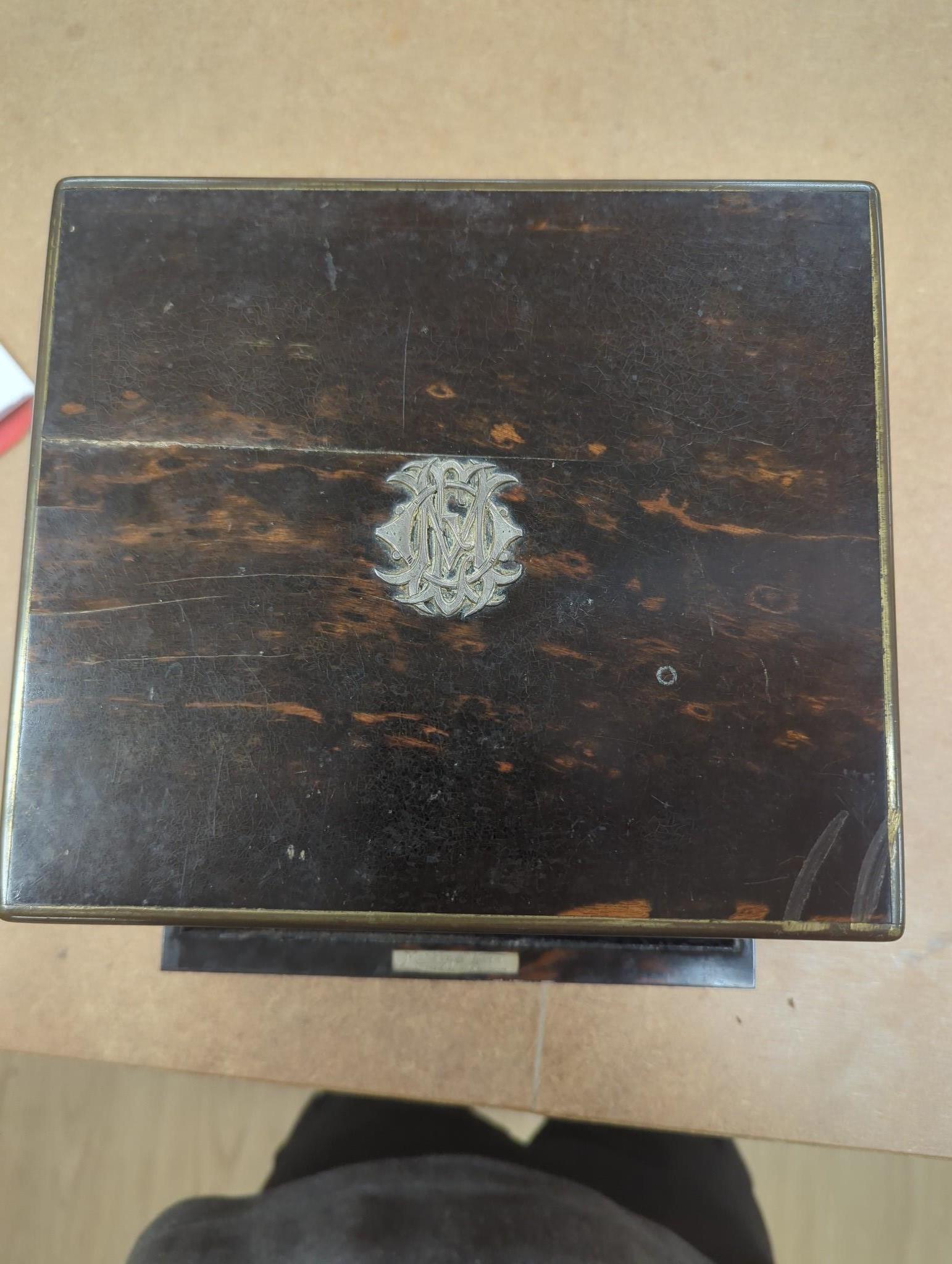 A late Victorian Mappin & Webb coromandel wood toilet box, containing ten silver mounted toilet jars, George Betjemann & Sons, London, 1895, box 21.2cm, mechanism for drawer a.f.